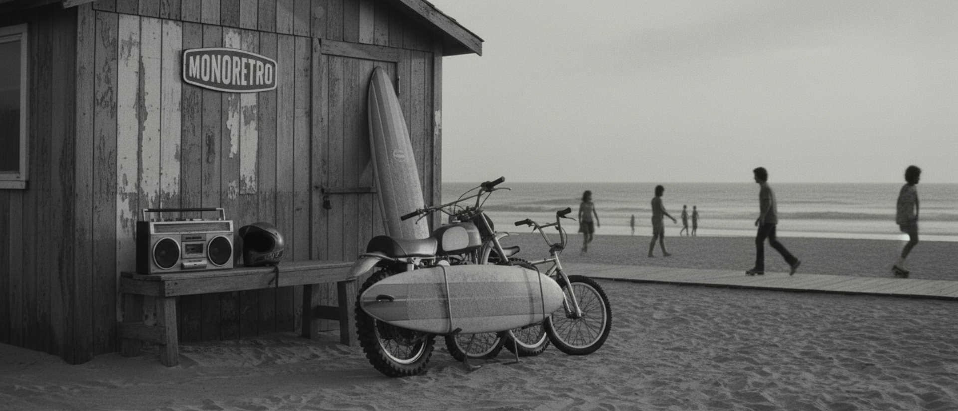 MONORETRO sign on a weathered beach hut, with a boombox and helmet resting on a bench in the sand.