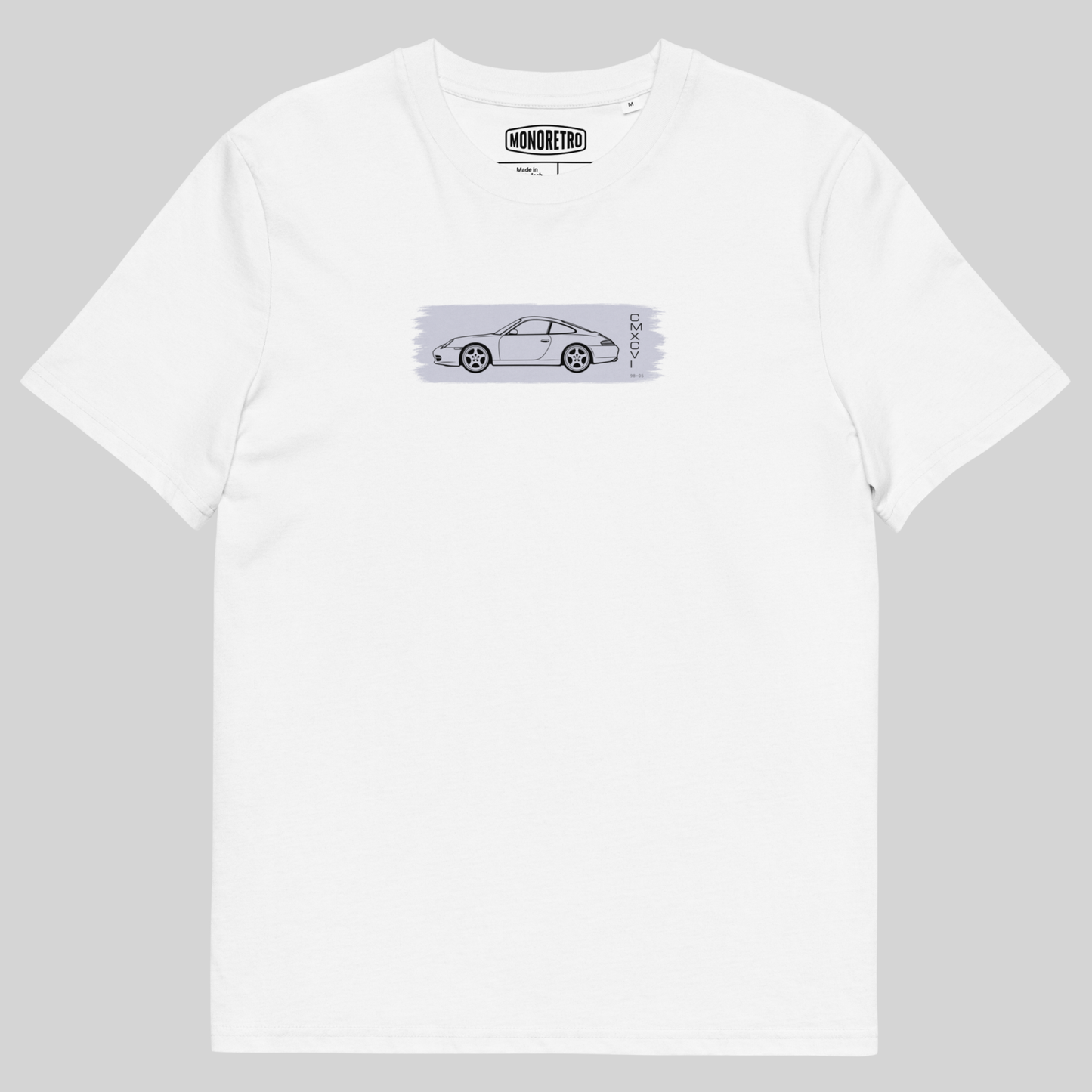 A white short-sleeve crewneck t-shirt featuring a horizontal graphic print of a silver sports car on a light gray textured background, with the 'MONSTER' brand logo printed inside the collar.