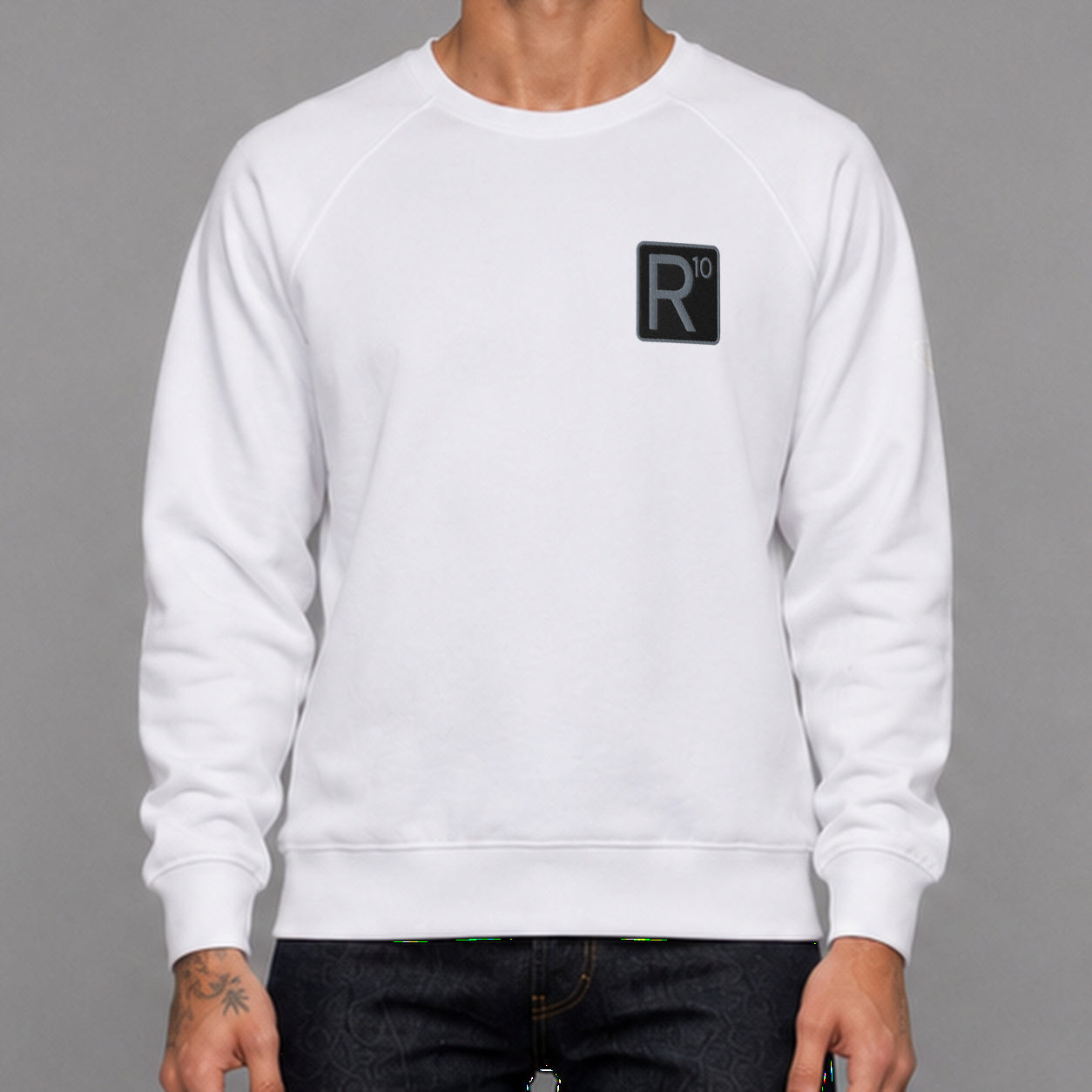 R10 Classic in white — worn by a male model, front detail.